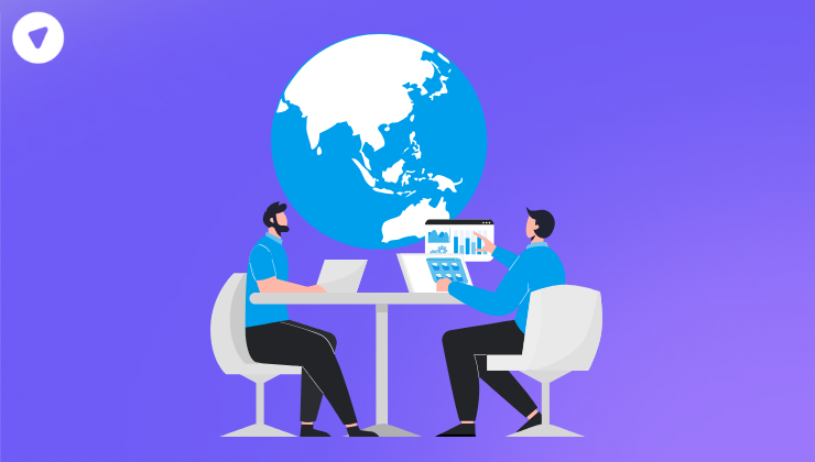 Two persons sitting on a table discussing business